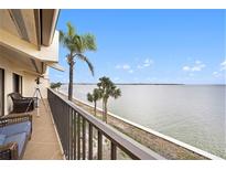 Spacious balcony overlooking the water with patio furniture at 7540 Sunshine Skyway S Ln # 220, St Petersburg, FL 33711