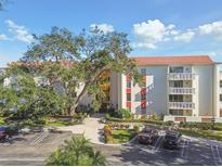 Stunning exterior view of condo building boasting well maintained landscaping and ample parking at 2650 Pearce Dr # 301, Clearwater, FL 33764