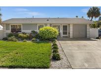 Cute bungalow with a nicely landscaped lawn and driveway at 709 Mandalay Ave, Clearwater Beach, FL 33767