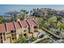 Aerial view of waterfront condos with private balconies and lush landscaping at 7550 Sunshine Skyway S Ln # T48, St Petersburg, FL 33711