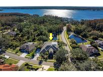Luxury home with pool, situated on a waterfront lot with lush landscaping at 3810 Executive Dr, Palm Harbor, FL 34685
