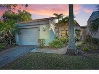 Charming single-story home with a well-maintained lawn and lush greenery at 165 Nina Way, Oldsmar, FL 34677