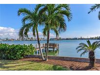Waterfront view with private dock and lush landscaping at 16323 Redington Dr, Redington Beach, FL 33708