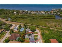 Aerial view showing a house with a pool, located near the water at 394 Ulelah Ave, Palm Harbor, FL 34683