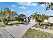 Single-Gathering home with a well-maintained lawn and driveway at 31935 Brookstone Dr, Wesley Chapel, FL 33545
