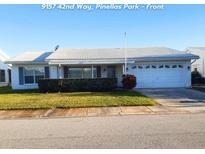 Charming single-story home with well-maintained landscaping and a two-car garage at 9157 42Nd N Way, Pinellas Park, FL 33782