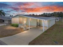 Single-story home with carport and screened porch at 3907 William Hume Dr, Zephyrhills, FL 33541