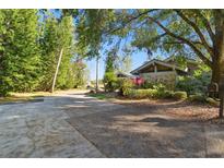 Landscaped driveway leading to a house with stone exterior at 5474 Kemkerry Rd, Wesley Chapel, FL 33543