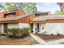 Inviting exterior of a condo with a landscaped walkway at 2064 Sunset Point Rd # 72, Clearwater, FL 33765