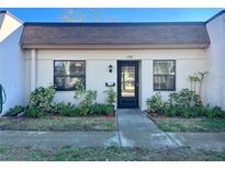 Inviting condo exterior with well-manicured landscaping and a private entrance at 2991 Flint S Dr # 77-D, Clearwater, FL 33759