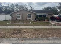 Ranch-style home with landscaped yard and driveway at 515 Cottage Ln, Brandon, FL 33510