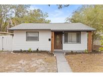 White house with gray roof, wood accents, and landscaping at 630 49Th N Ave, St Petersburg, FL 33703