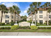 Beach Harbor Club condo building, featuring a welcoming entryway and landscaping at 3806 Gulf Of Mexico Dr # C211, Longboat Key, FL 34228