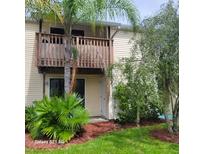 Exterior view of condo building with balcony and landscaping at 122 Loblolly Ct # H, Oldsmar, FL 34677