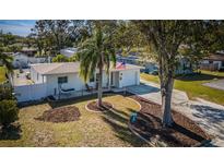 Cute bungalow with mature landscaping and a spacious front yard at 3168 Meadow Lake Ave, Largo, FL 33771