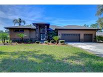 Beautiful two-story home with stone accents and a three-car garage at 8345 Shenandoah Run, Wesley Chapel, FL 33544