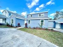 Charming light blue two-story home with landscaped yard and concrete driveway at 1741 25Th N Ave, St Petersburg, FL 33713