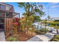 Scenic waterfront property with private canal access and lush landscaping at 9386 Tradewinds Ave, Seminole, FL 33776