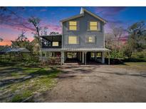 Two-story house exterior at dusk, elevated, screened porch, and large yard at 4501 Keene Rd, Plant City, FL 33565