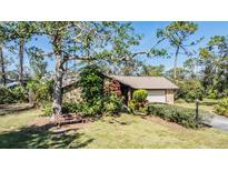 Single-story home with stone accents and a spacious lawn at 4595 Northwood Ter, Sarasota, FL 34234