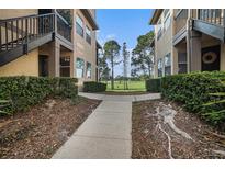 Walkway leading to condo with view of golf course at 2400 Feather Sound Dr # 418, Clearwater, FL 33762