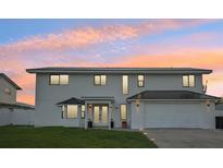 Two-story modern home with white exterior, dark metal roof, and attached garage at 380 Colony Point S Rd, St Petersburg, FL 33705