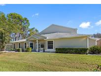 Exterior elevation showing the front of the house and large front yard at 3203 Audubon Ct, Tarpon Springs, FL 34688