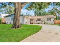 Charming stone house with a large tree and landscaped yard at 8253 137Th Ln, Seminole, FL 33776