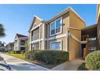 Two-story condo building with red tile roofs and landscaping at 9481 Highland Oak Dr # 807, Tampa, FL 33647