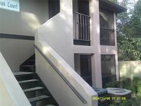 Exterior view of condo building with stairs and screened balcony at 4036 Angel Oak Ct # 101, Tampa, FL 33613