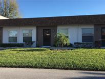 Exterior view of condo, featuring a brown roof and well-maintained lawn at 6177 Chesham Dr # 6, New Port Richey, FL 34653