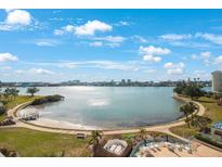 Aerial view of waterfront property with a community pool and lush landscaping at 7902 Sailboat Key S Blvd # 405, South Pasadena, FL 33707