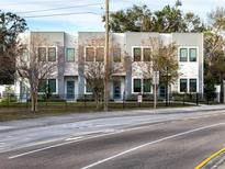 Modern townhouses with gray siding and landscaped yards at 2108 E 22Nd Ave # 4, Tampa, FL 33605