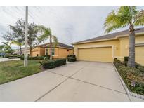 Two-car garage villa with landscaped yard and driveway at 2311 Nottingham Greens Dr # 2311, Sun City Center, FL 33573