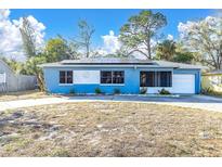 Cute blue house with solar panels and a spacious yard at 4825 Dr Martin Luther King Jr S St, St Petersburg, FL 33705