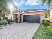 Charming one-story home with stone accents and a brick-paved driveway offers great curb appeal at 10227 Count Fleet Dr, Ruskin, FL 33573