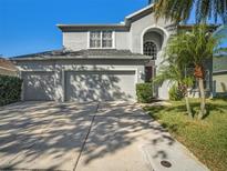 Two-story house with three-car garage and landscaped lawn at 12427 Adventure Dr, Riverview, FL 33579