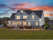 Two-story house with gray siding, white trim, and a covered porch at 12527 Pompanic St, San Antonio, FL 33576