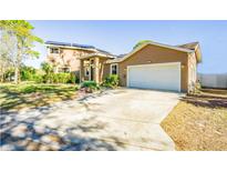 Two-story house with a large driveway and attached garage at 131 Mystic Lake N Dr, St Petersburg, FL 33702
