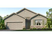 Single-story house with a two-car garage and stone accents at 1716 Tahitian Sunrise Dr, Plant City, FL 33565