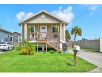 Cute raised bungalow home with front porch and well-maintained lawn at 5310 Van Doren Ave, New Port Richey, FL 34652