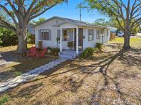 Charming bungalow with a well-manicured lawn and a welcoming front porch at 5570 4Th N Ave, St Petersburg, FL 33710