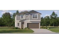 Two-story home with gray siding, brown garage door, and landscaping at 17542 Shirewood Way, Land O Lakes, FL 34638