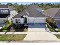 Two-story house with a three-car garage and landscaped yard at 5418 Wayfarer Ave, Apollo Beach, FL 33572