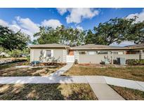 Tan single story home with white fence and walkway at 11805 Northtrail Ave, Temple Terrace, FL 33617