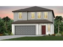 Two-story home with gray siding, brown roof, and a two-car garage at 6229 Golden Beach Dr, Apollo Beach, FL 33572