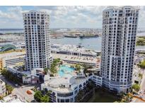 Aerial view of a luxurious condo building with a pool and water access at 1209 E Cumberland Ave # 906, Tampa, FL 33602