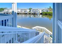 Steps leading down to waterfront with boat and water views at 5176 Se Salmon Se Dr # D, St Petersburg, FL 33705