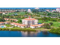 Aerial view of condo building near water, golf course, and bridge at 6104 Palma Del Mar S Blvd # 404, St Petersburg, FL 33715