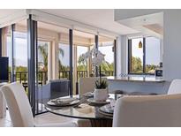 Condo dining area with glass table, off-white chairs, and balcony view at 6104 Palma Del Mar S Blvd # 404, St Petersburg, FL 33715